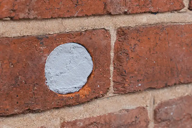 Brick wall with drilled hole filled Flexi Armour Seal